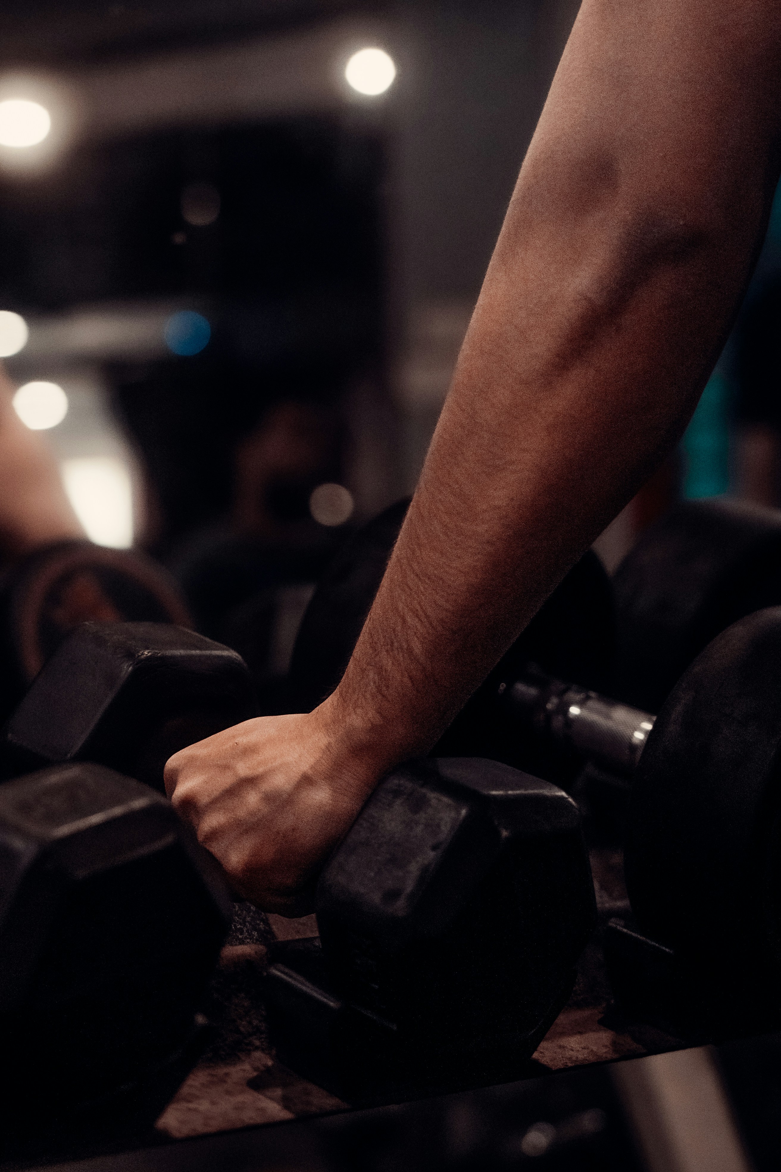 A close up of a person lifting a barbell