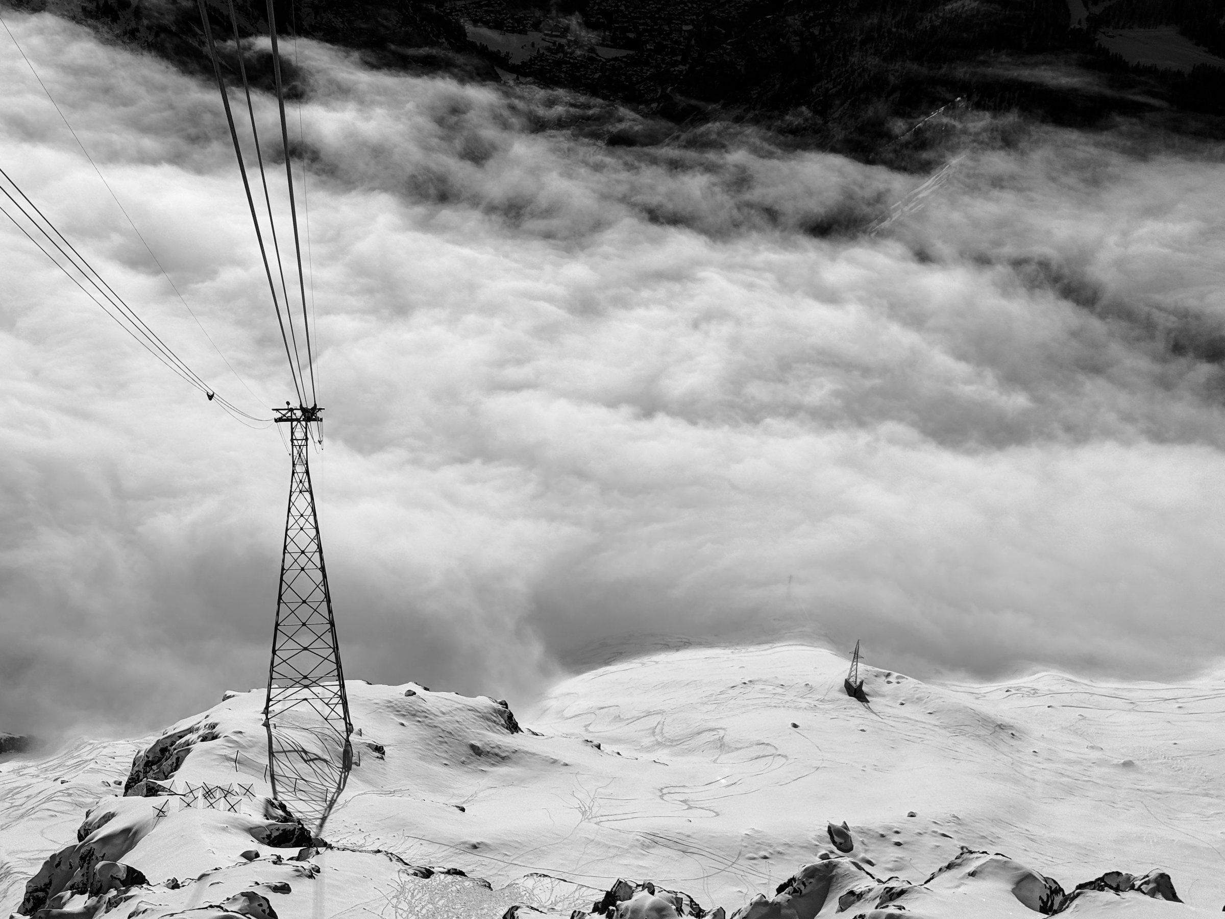 Cable-car pylon and cables above a sea of clouds on the Skyway Monte Bianco, Italian Alps