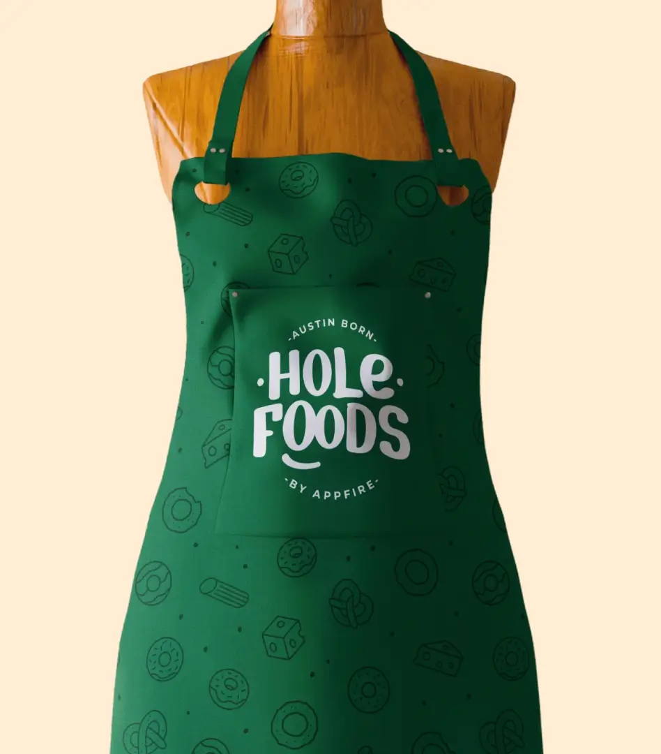 Scattered Hole Foods pinback buttons in green, orange, and brown, one featuring a pretzel and another the 'Snack bold, Live whole' tagline.
