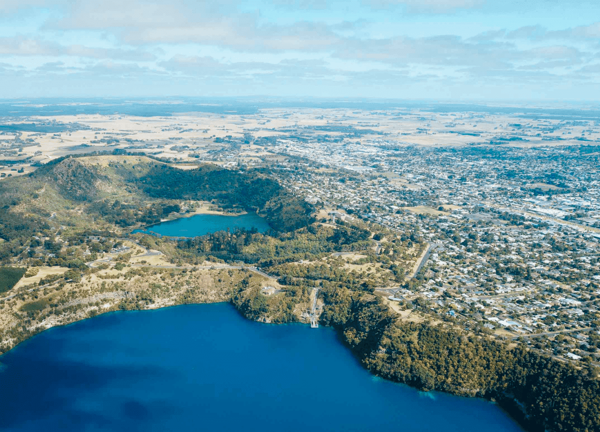 Aerial view of twin blue lakes beside a town.