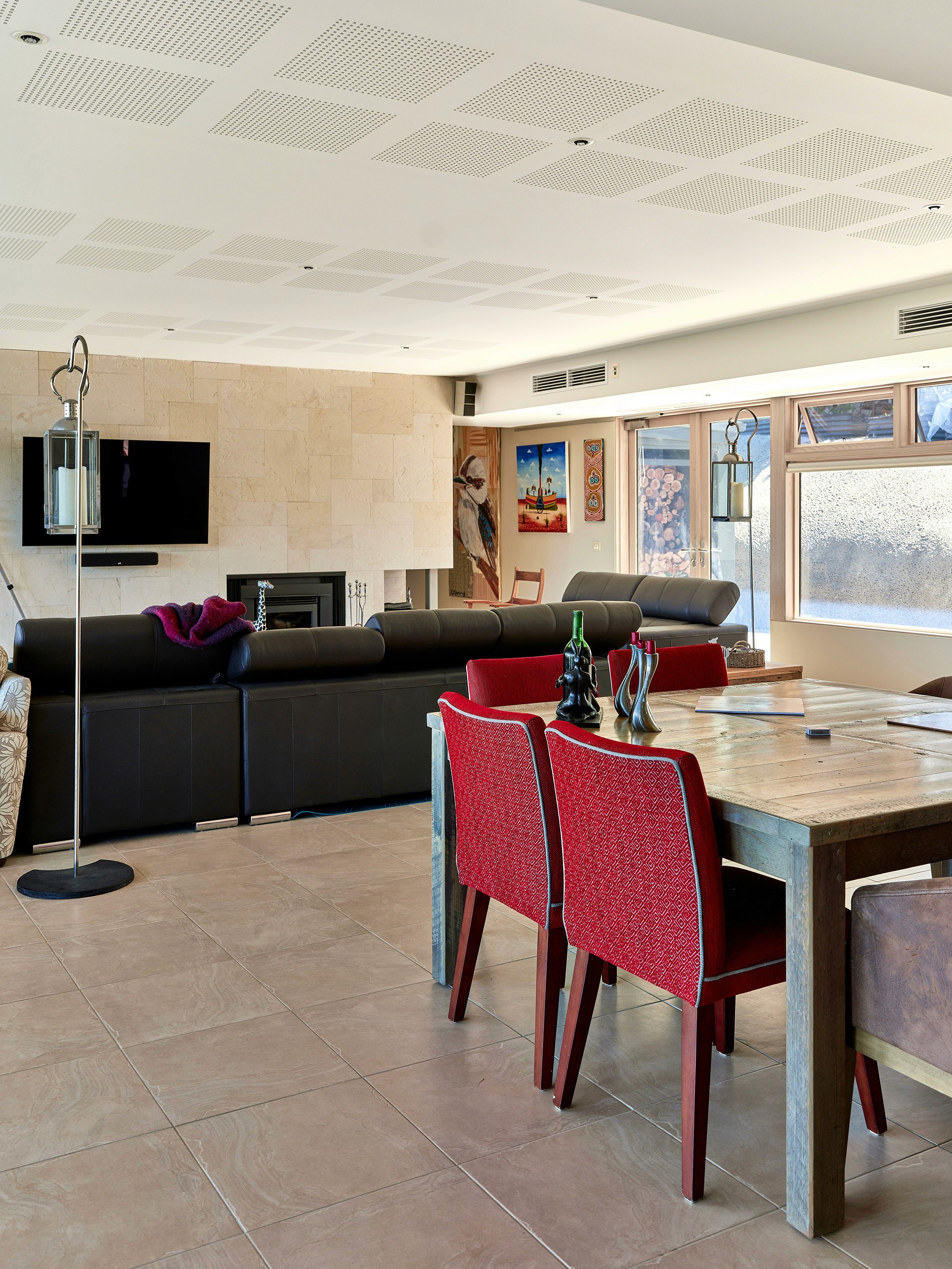 Dining area with red chairs and a view of the living room