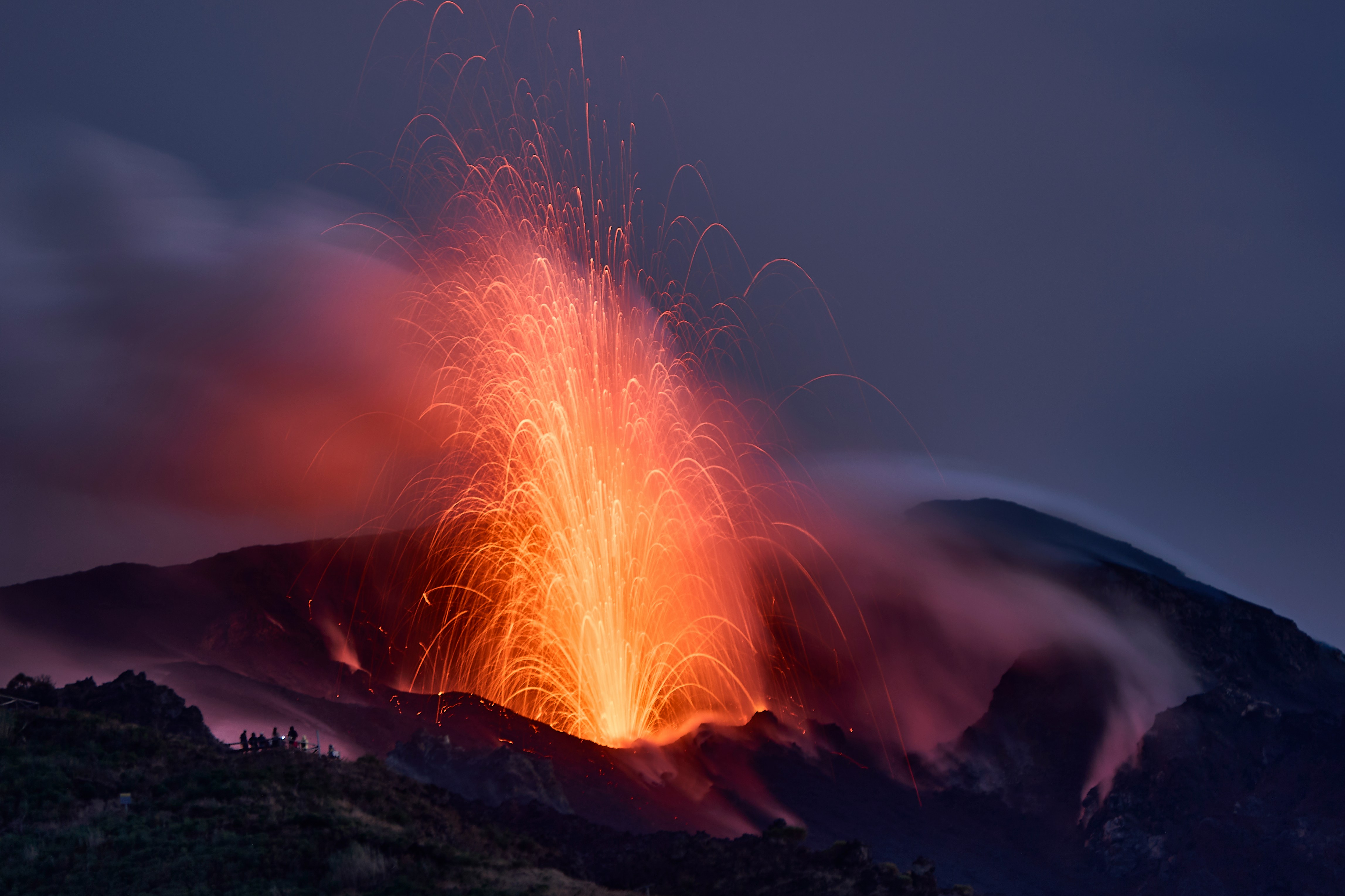 Volcano erupting with glowing lava and smoke