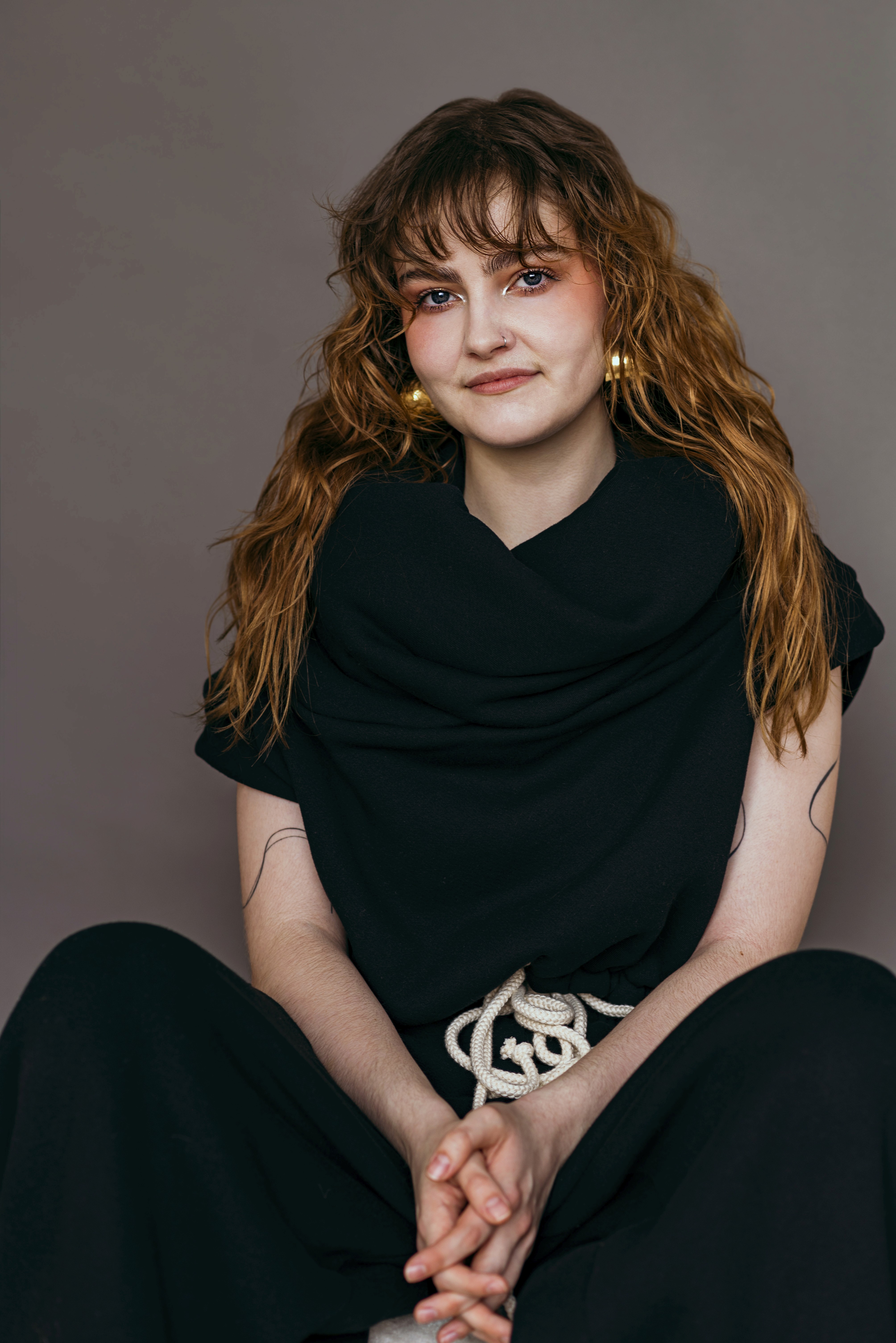 headshot of Jessie Christie in black sweater grey background