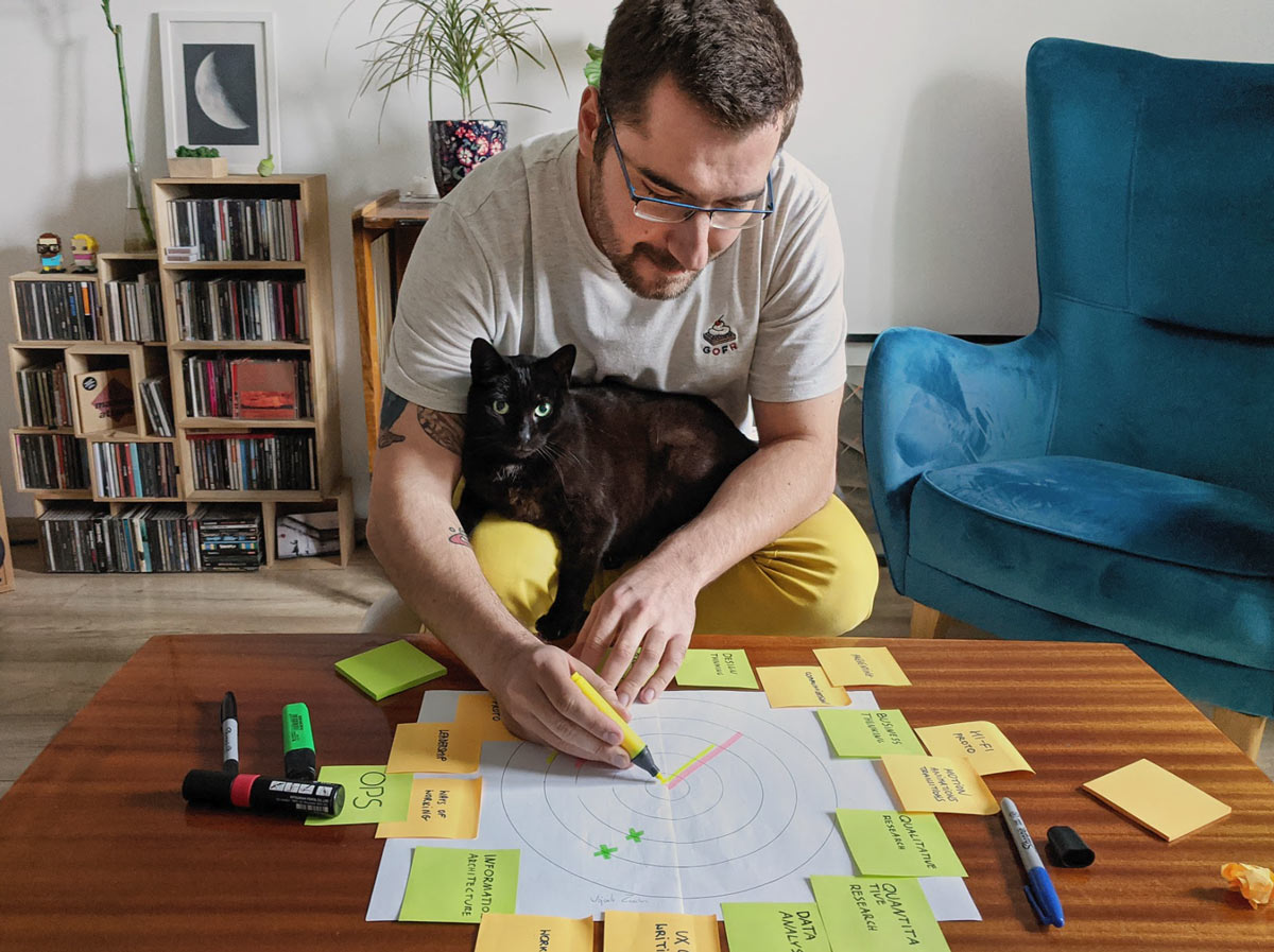 Ux designer sitting in his living room and sketching a graph 