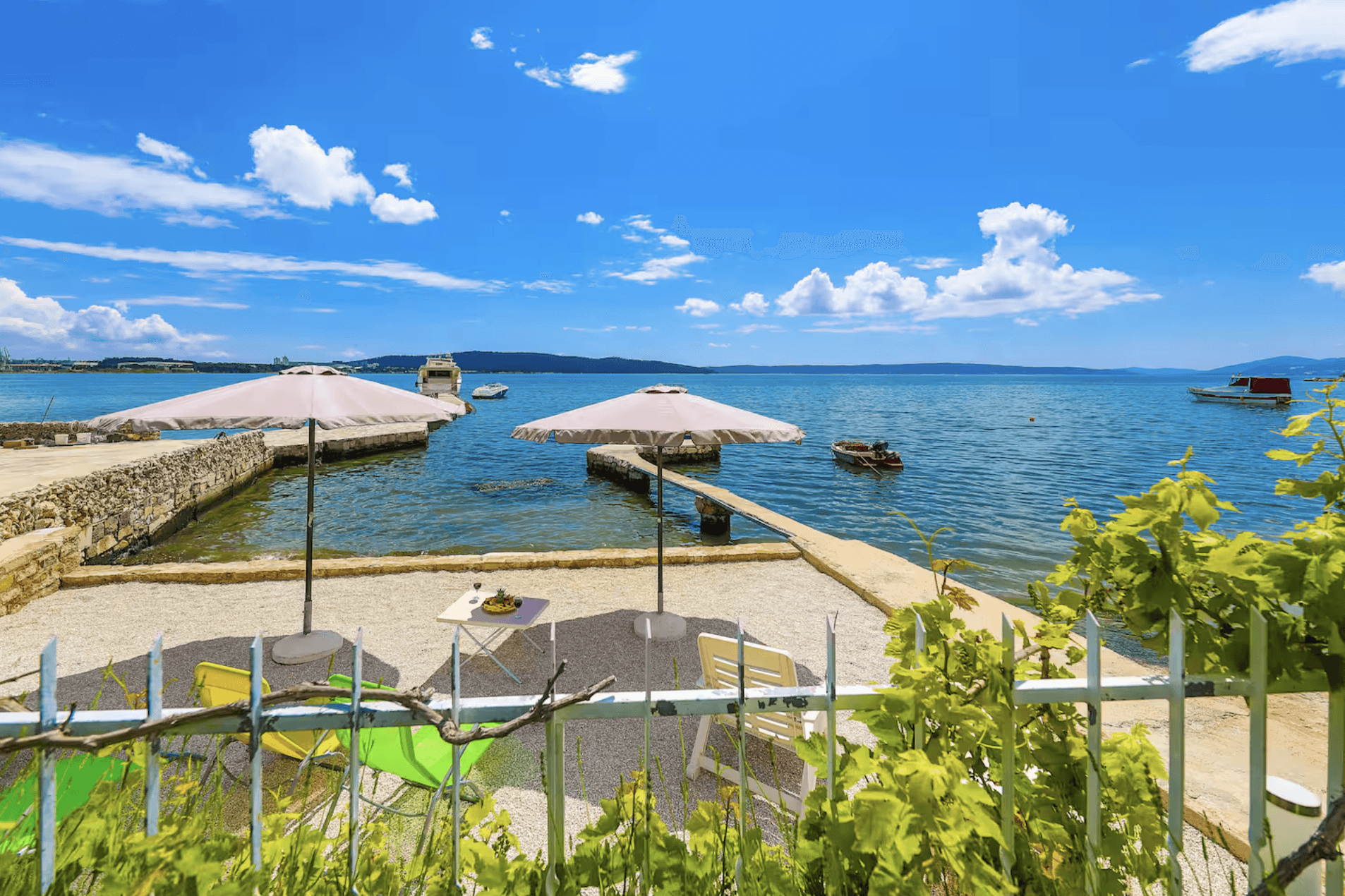Bedroom with wall bookshelf and mountain view.