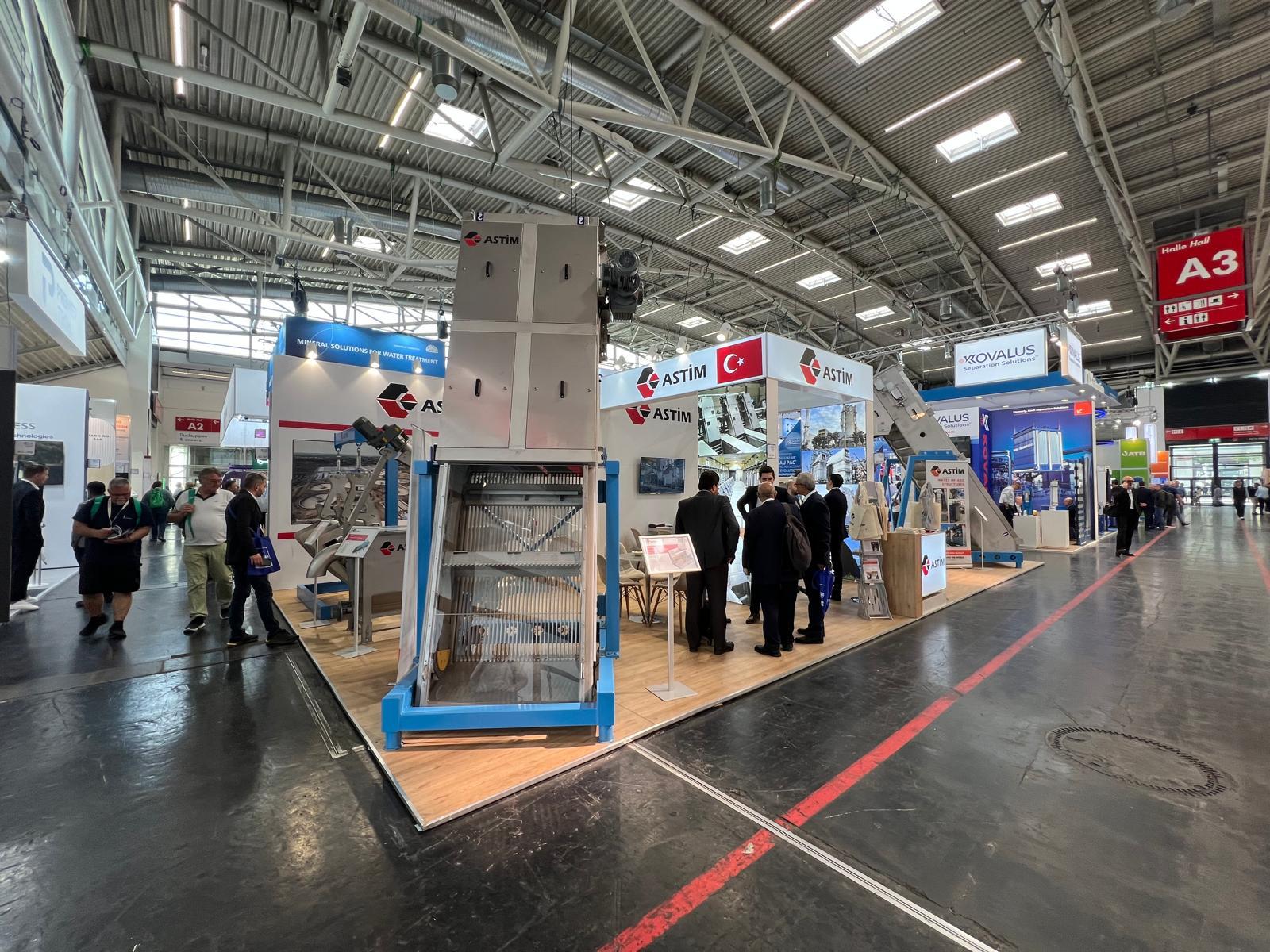 Large industrial machine displayed directly inside the ASTIM stand, supported by strong flooring and 3‑phase power infrastructure.