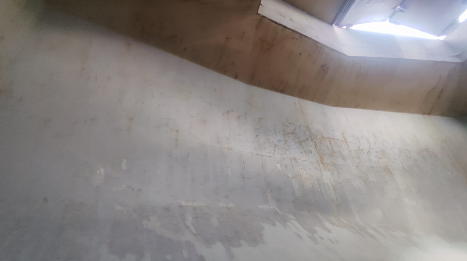 Cargo hold upper bulkhead and hatch coaming area after cleaning, with residual streaking visible from previous coal cargo.