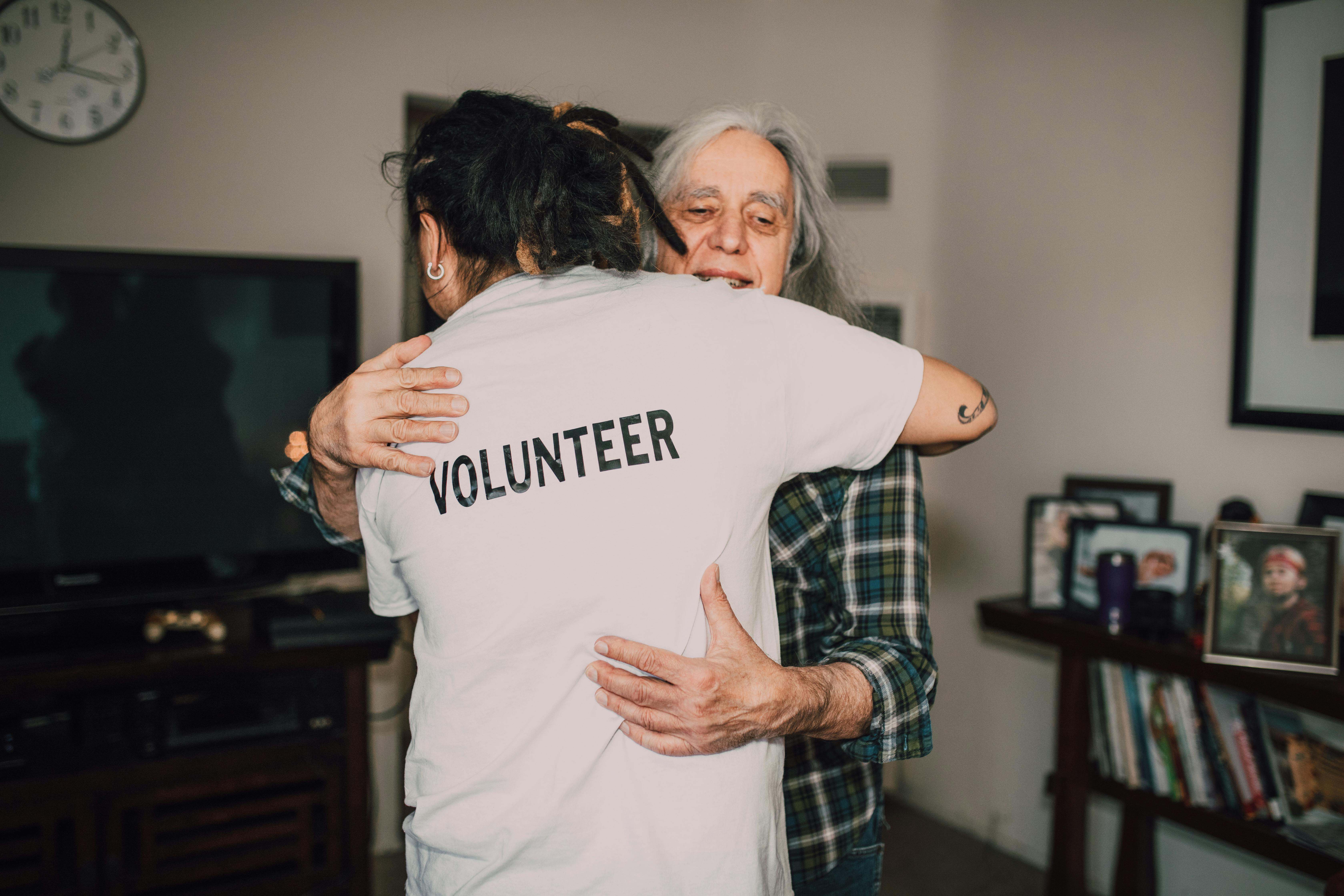 Volunteers helping an old woman