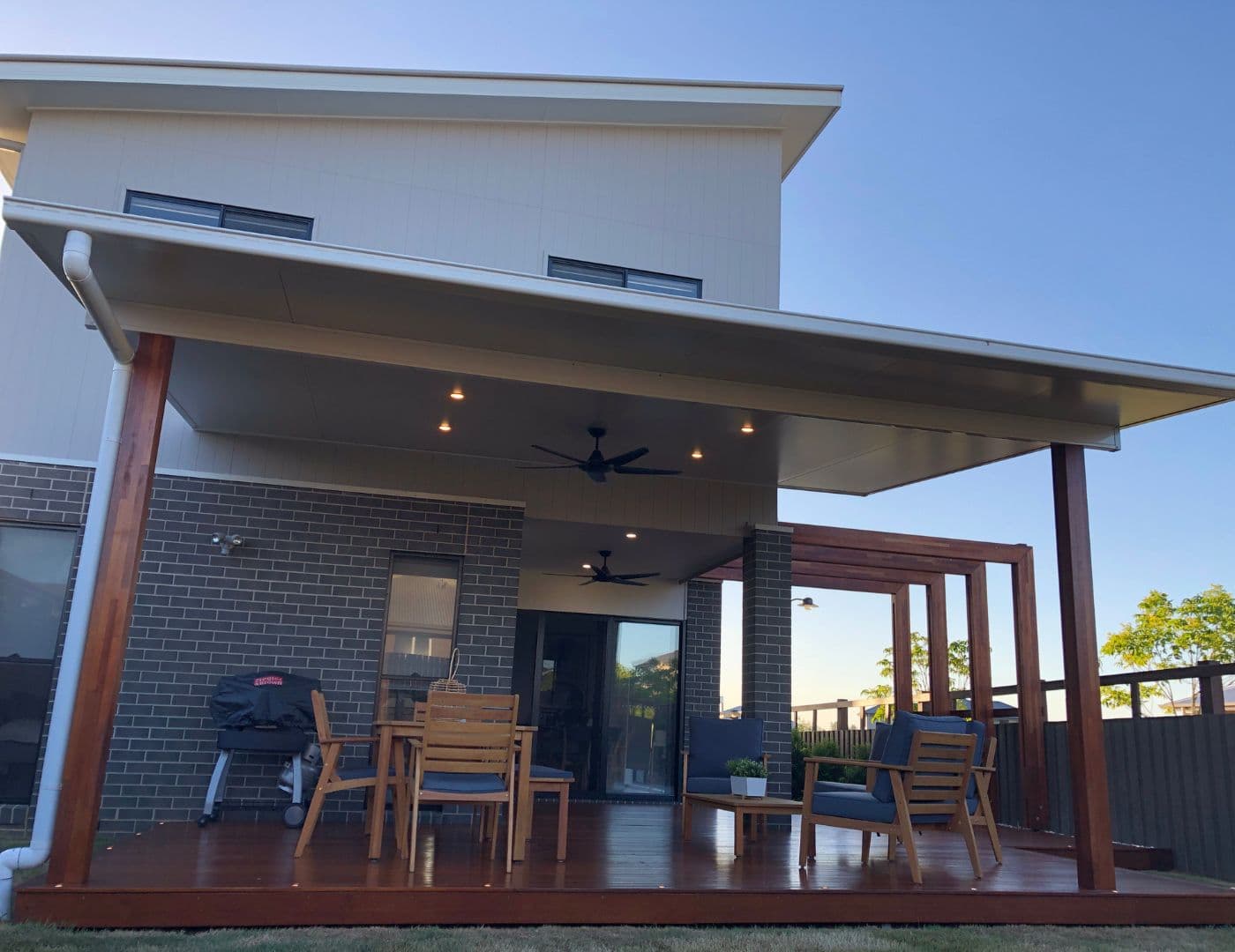 Modern outdoor living area with covered patio and wooden deck in a Brisbane home.