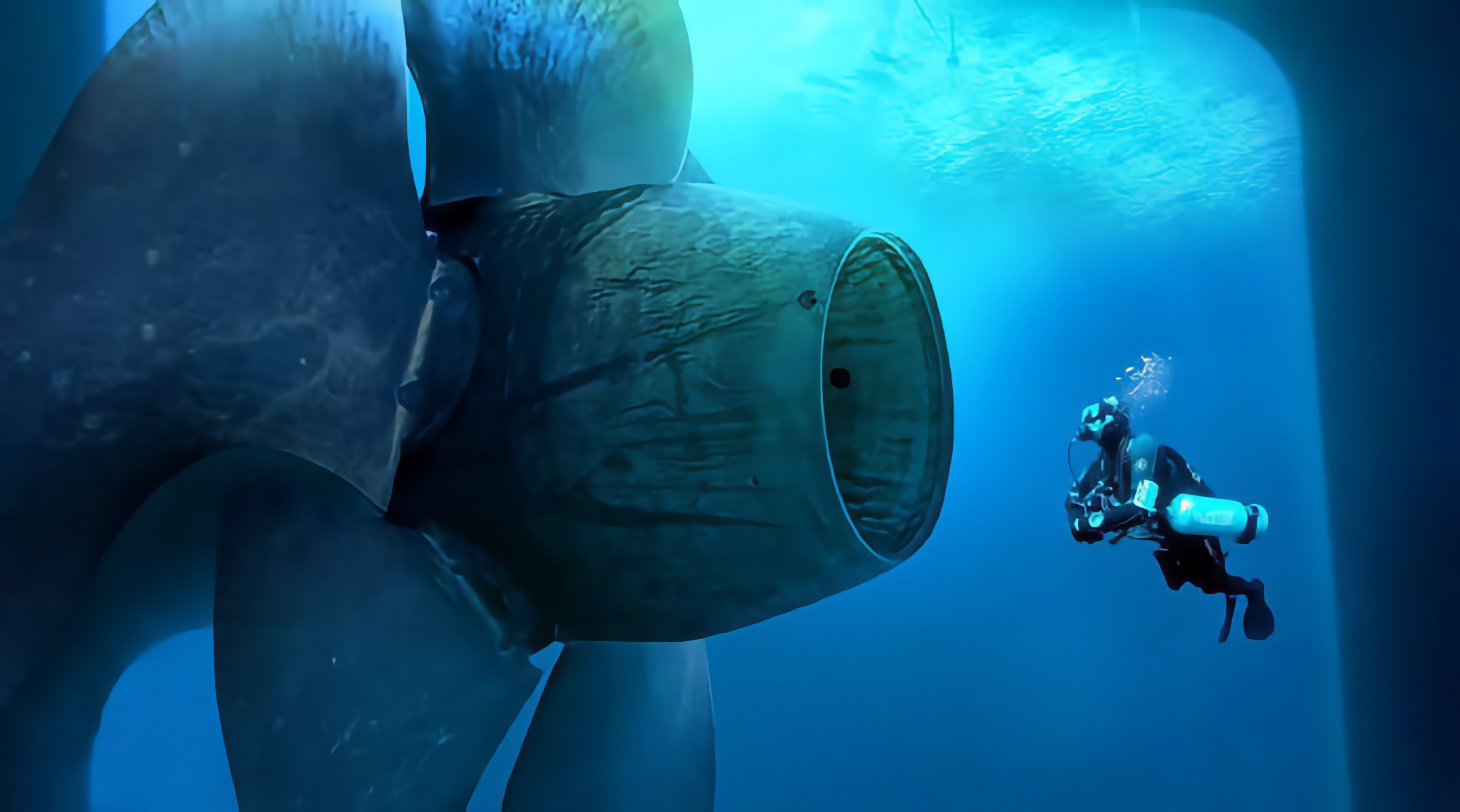 Commercial diver conducting a subsea tactical inspection of a massive ship propeller boss cap and blades to assess hydrodynamic condition and micro-roughness.
