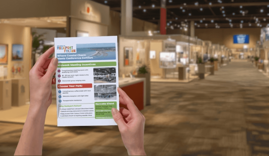 person holding a brochure at a tradeshow