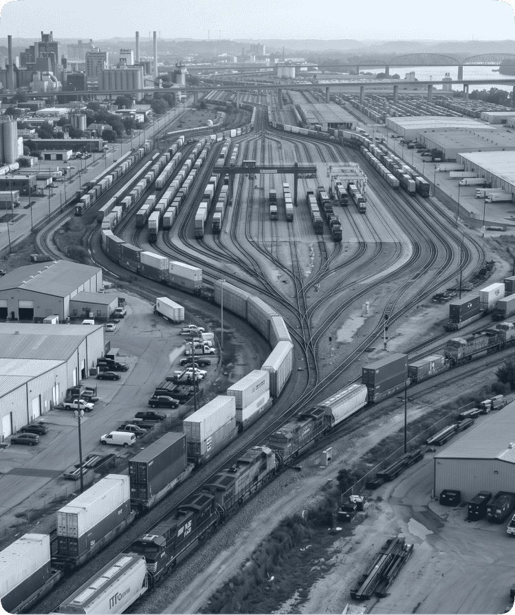 Semi‑truck passing passenger car on highway near warehouses representing trucking safety and traffic risk