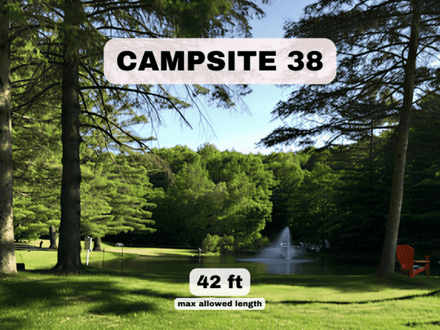 Campsite 38 at Pine Hollow Campground, a 42ft pondfront RV site with an Adirondack chair and a view of the fountain