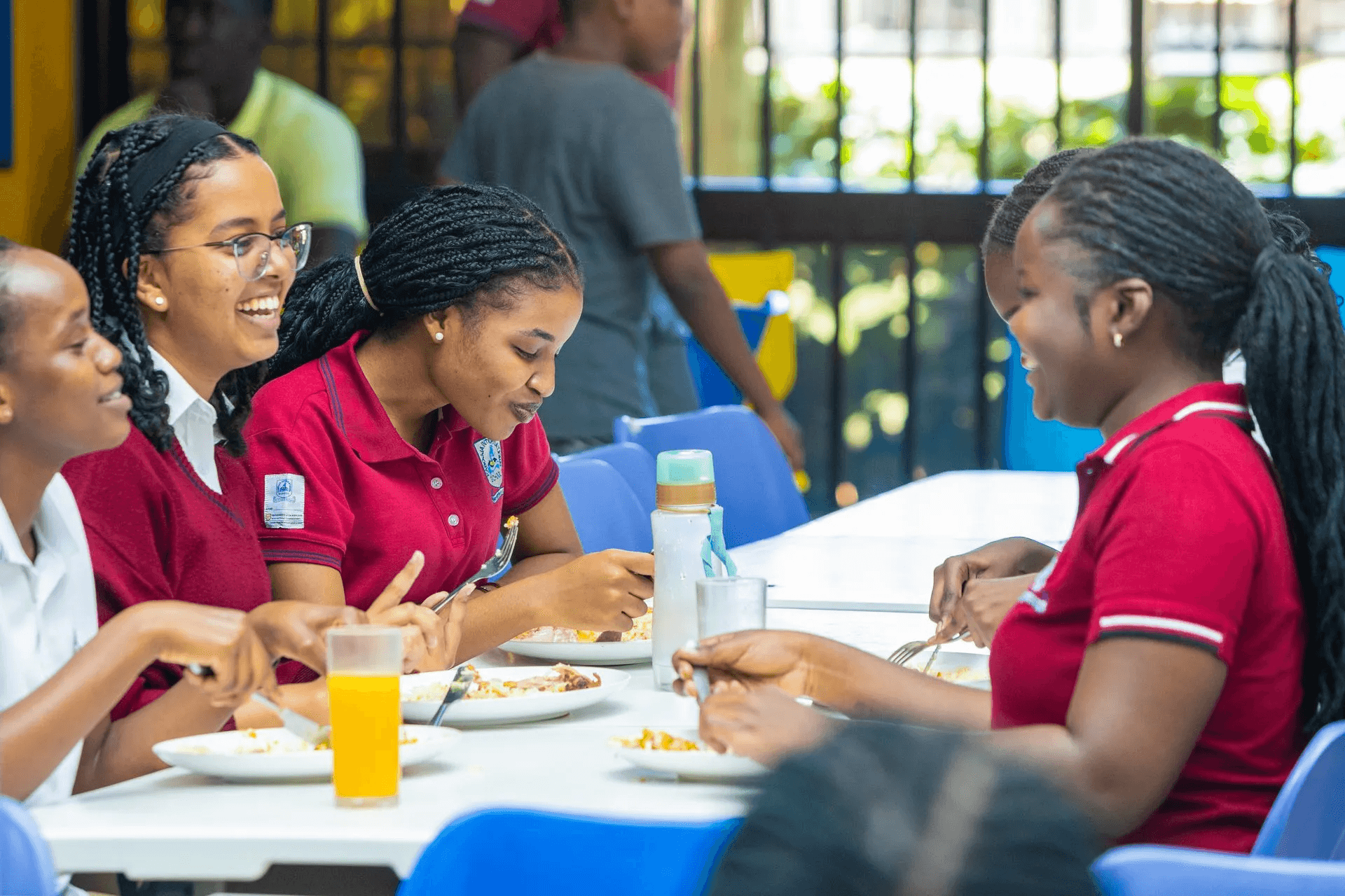 A teacher is explaining a topic to the class, speaking with gestures to emphasize points