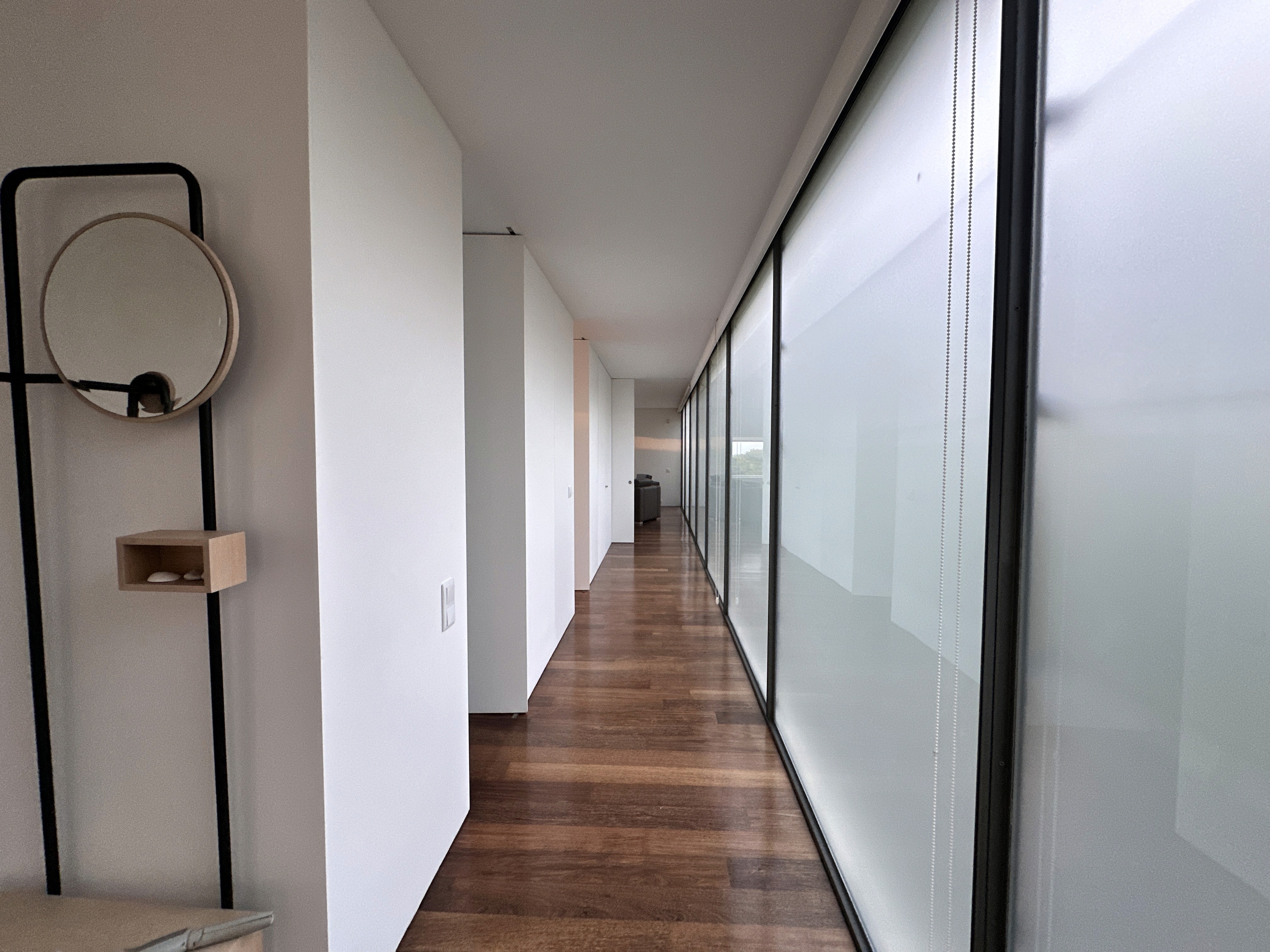 Modern hillside home with terracotta urn and mountain view