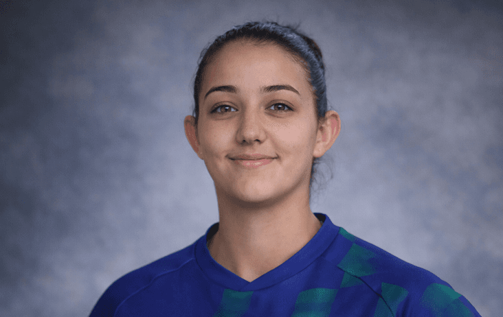 smiling woman wearing white and black pinstriped collared top