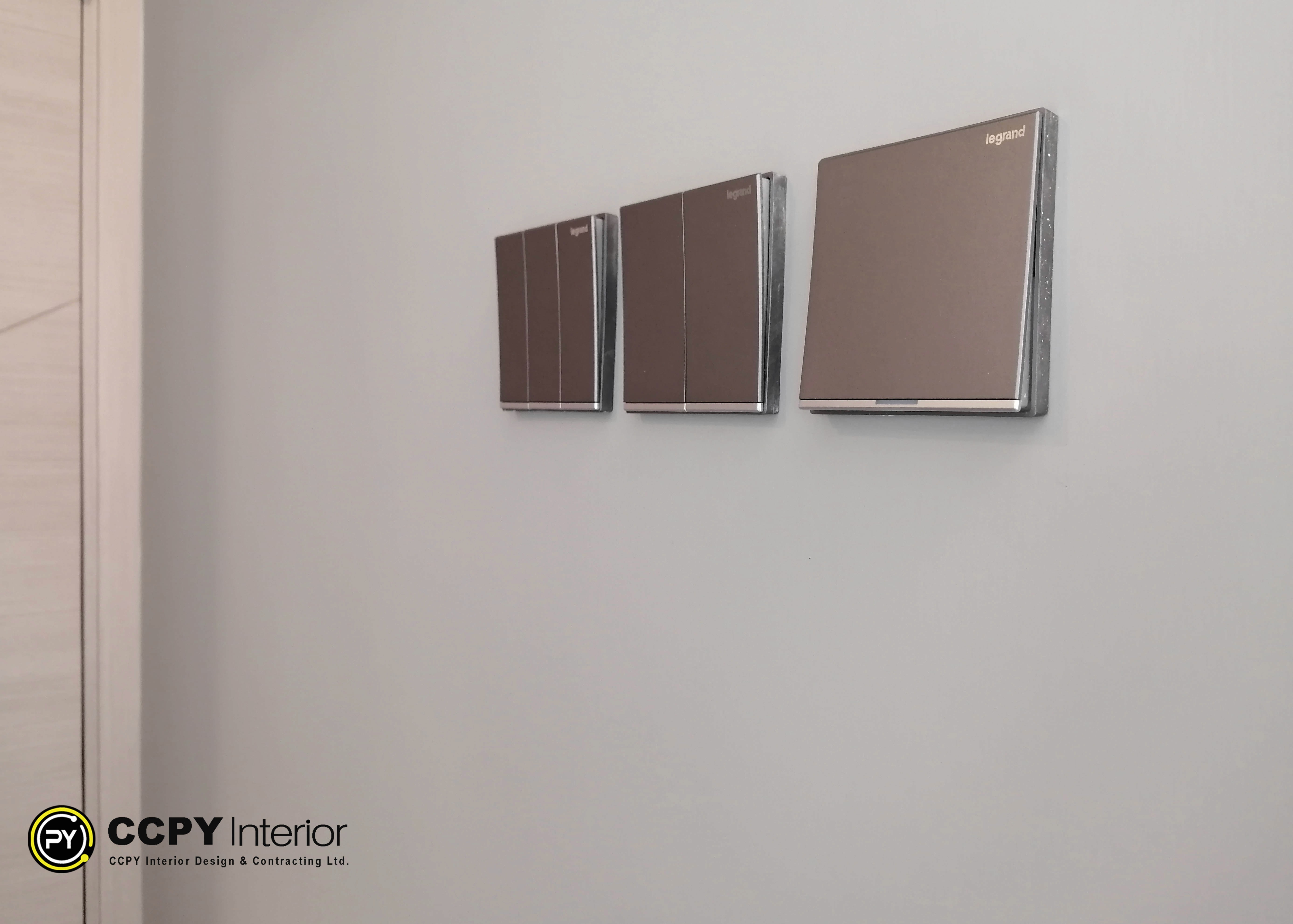 Modern entry foyer at Mount Pavilia 20 highlighting high-gloss paneled walls, sleek elevator access, and a distinctive monochrome geometric floor pattern.