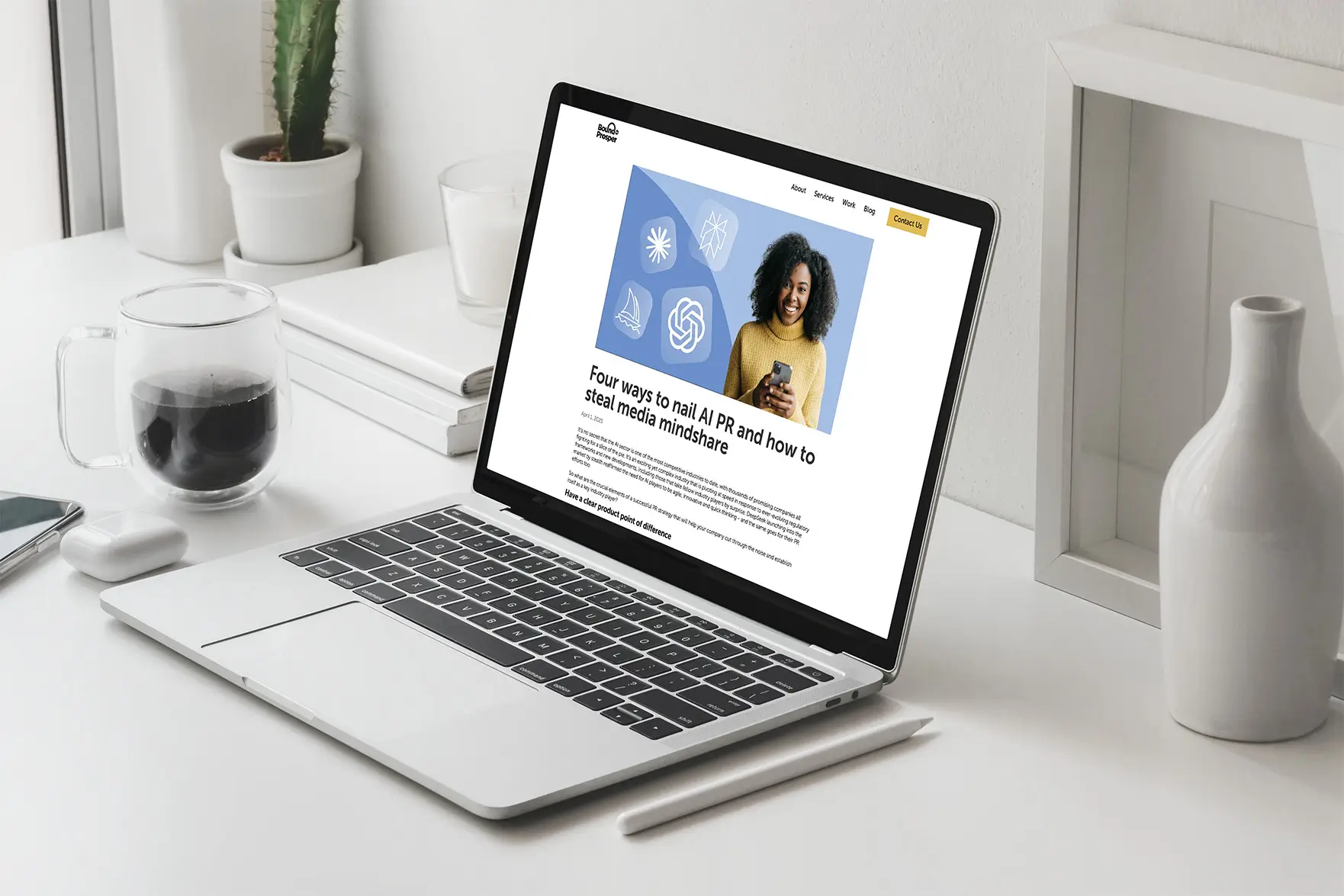 A laptop on a desk displays a digital illustration, surrounded by a glass of water and decorative vases.