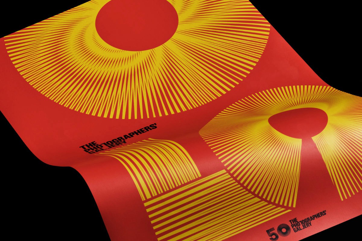 Two circular objects in yellow and orange on a red background, resembling stylized number "50", celebrating The Photographers' Gallery's 50th anniversary.