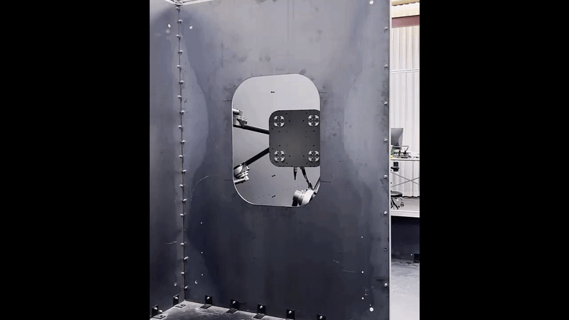 A quadrupedal robot Spider with magnetic feet passes through an access hole in a steel bulkhead. The same actuator module supports a body that climbs steel surfaces while carrying heavy equipment.