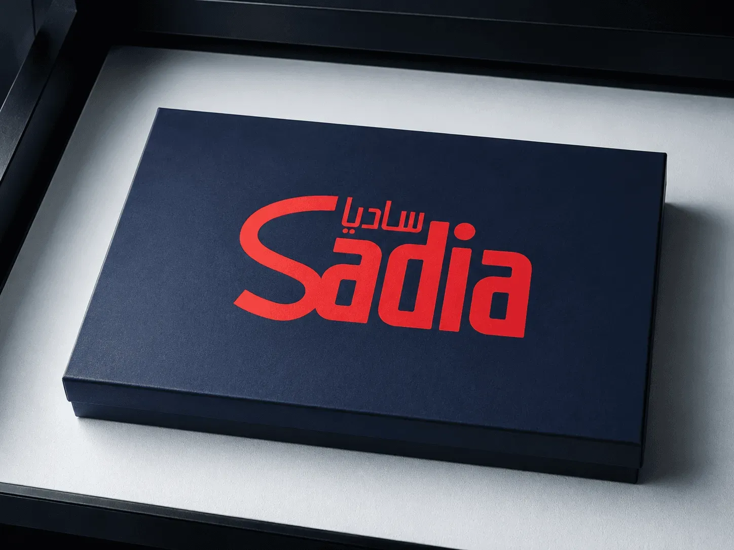 Open Sadia gift box with branded notebook, bottle, tumbler, keychain, and pen
