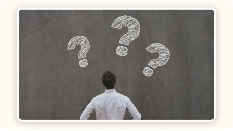 Man facing large question marks