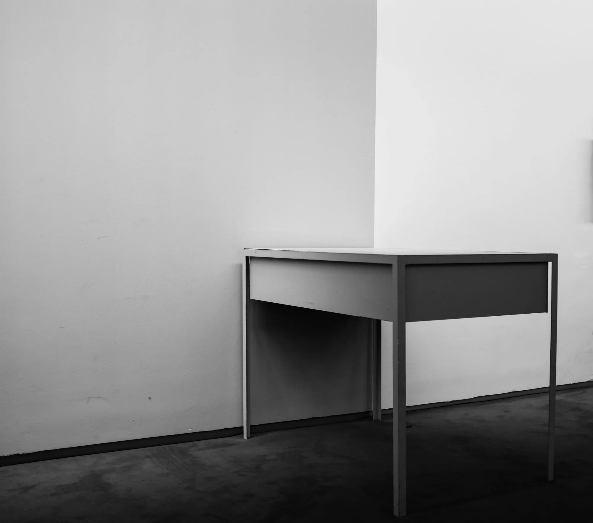 Studio desk against a bare wall