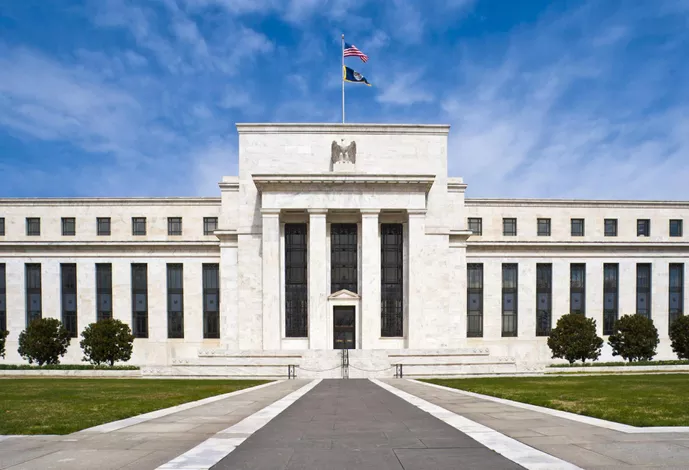 The Federal Reserve building in Washington, DC, showcasing its neoclassical architecture and prominent columns.