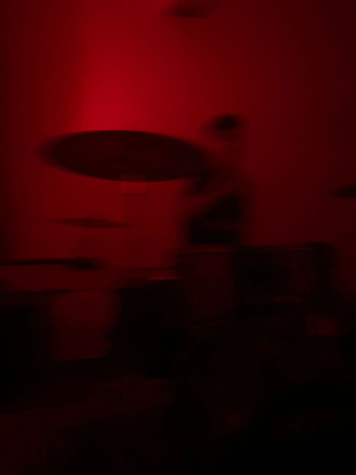 a blurry photo of a person standing in front of a wall