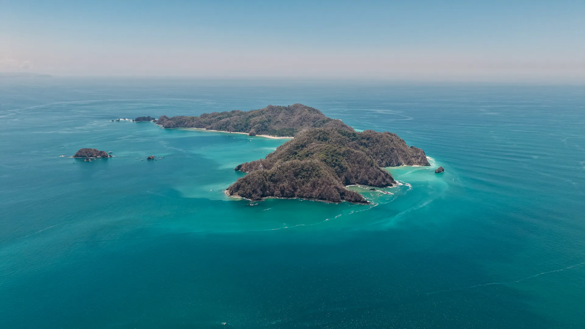 Aerial view of Isla Tortuga surrounded by turquoise water in the Gulf of Nicoya, Costa Rica