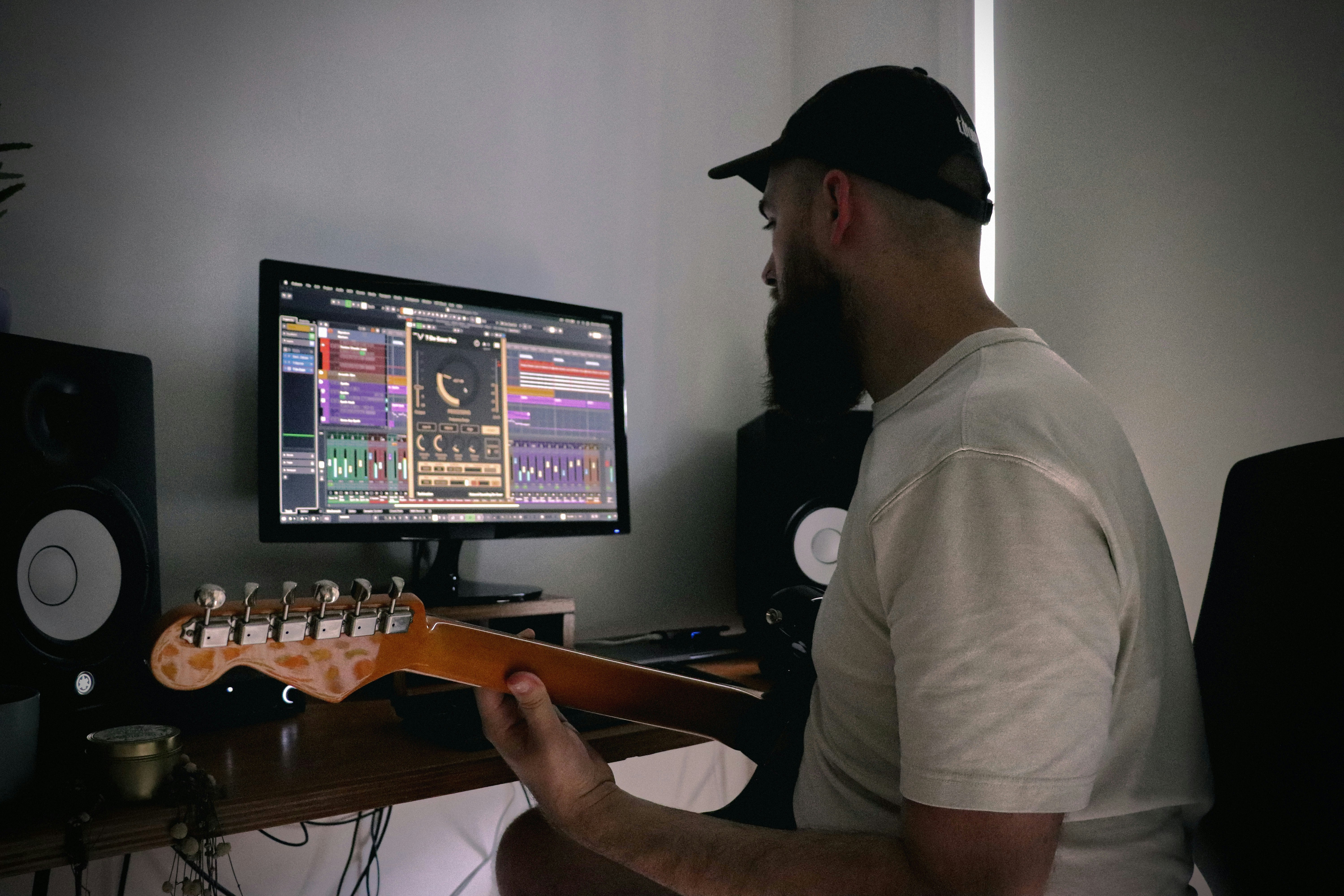 man infront of his computer - Music Production Workflow