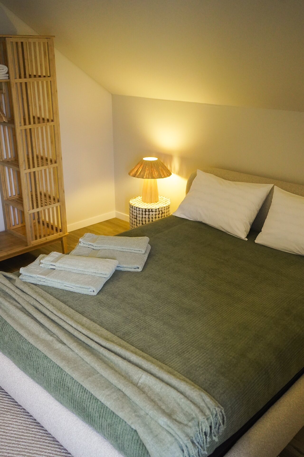 Cozy bedroom with warm lamp lighting at Villa Flora eco villa Portugal