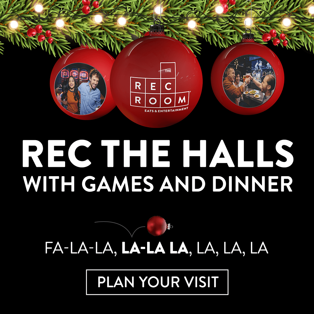 Hand holding waffle cone with three scoops of colorful pastel ice cream