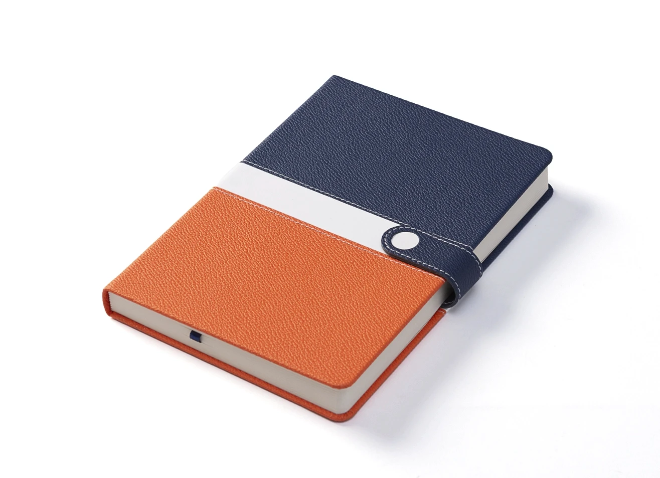 Angled view of closed notebook showing textured cover and snap closure.