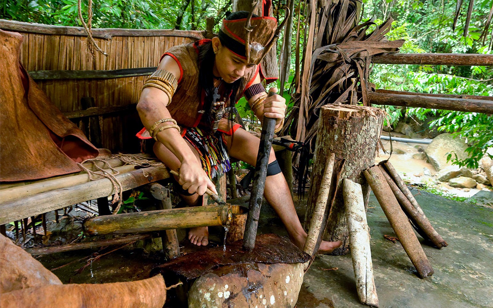 Man demonstrating traditional craft at Mari Mari Cultural Village tour.