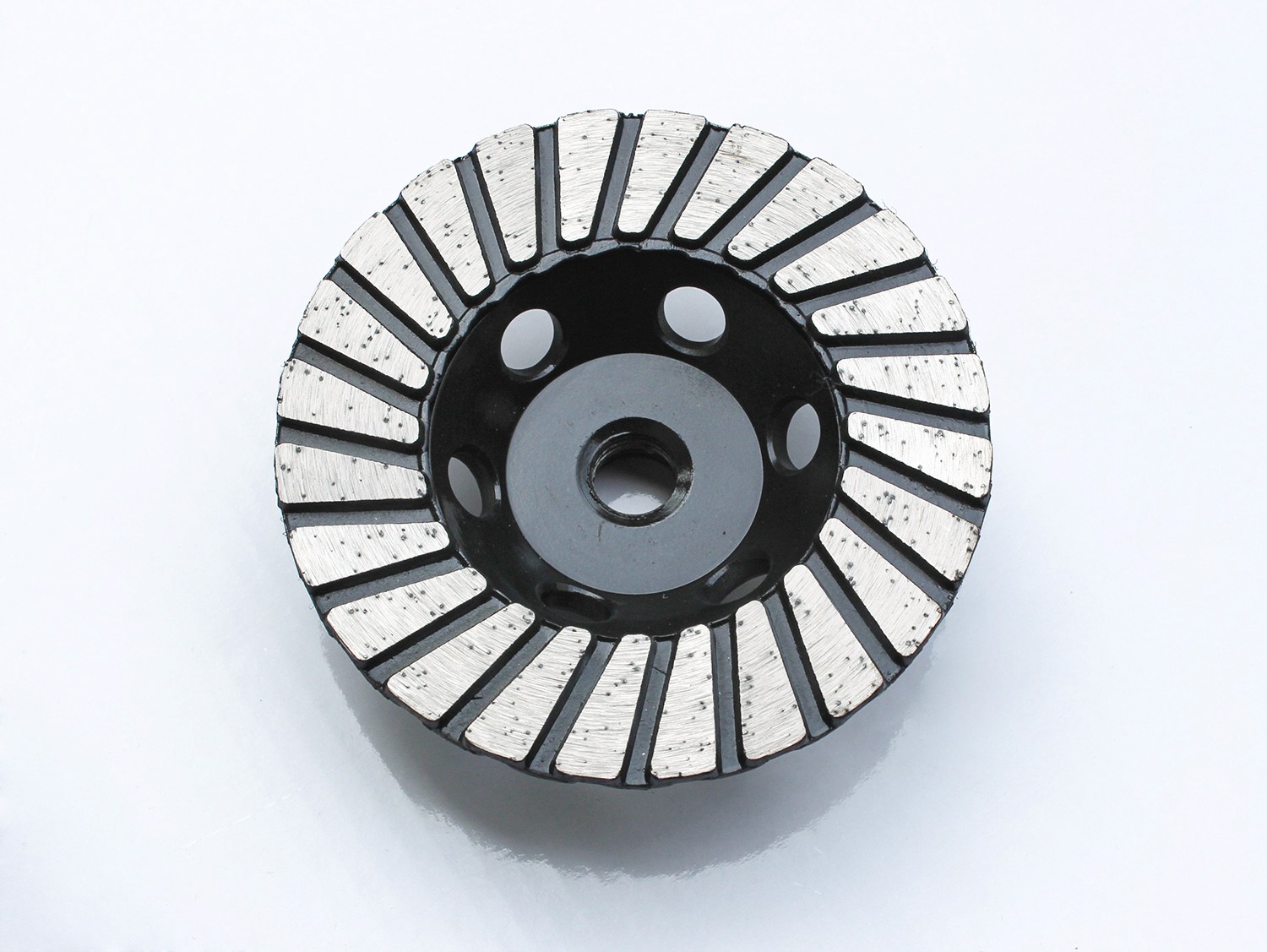 Close-up of a Diamond grinding cup wheel with a black segmented design for concrete and stone grinding.