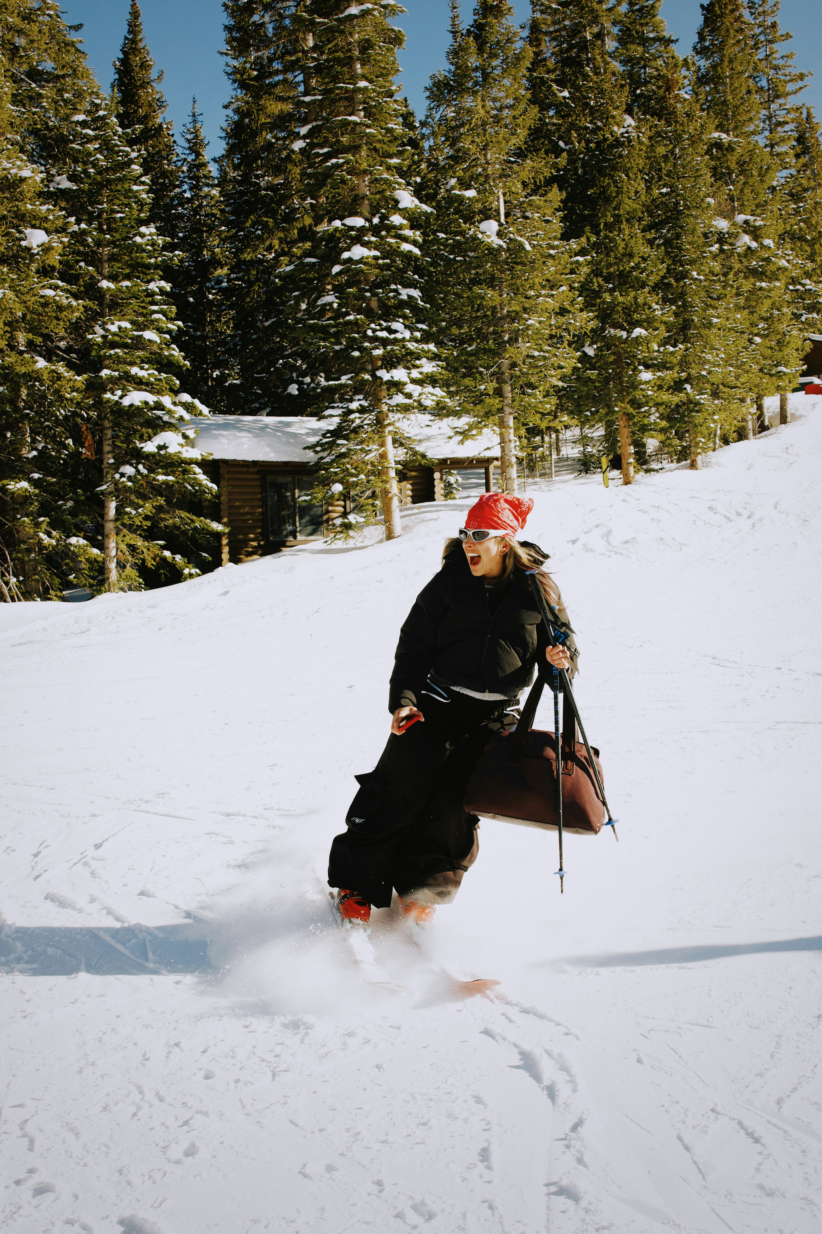 A skier with a bag on a snowy slope