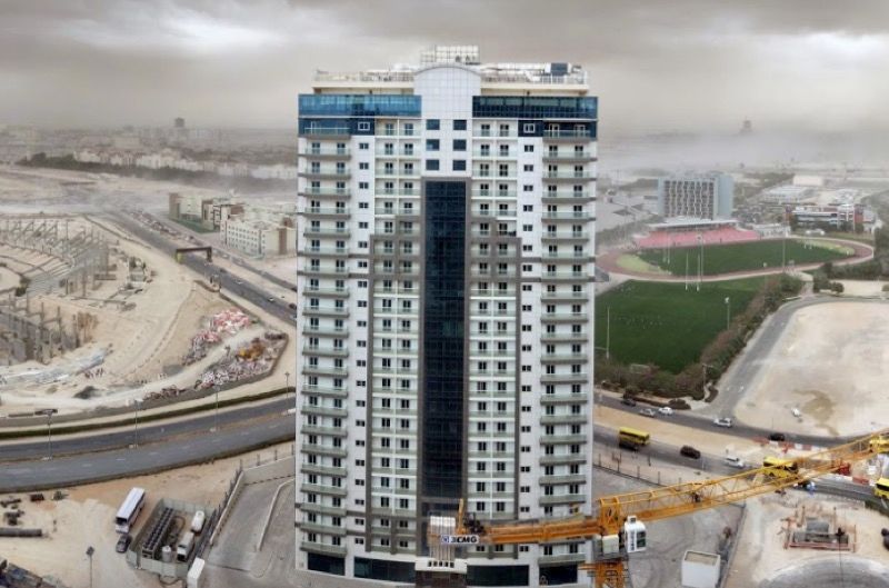 Aerial view of Red Residence in a developing urban area, premium real estate investment opportunity.