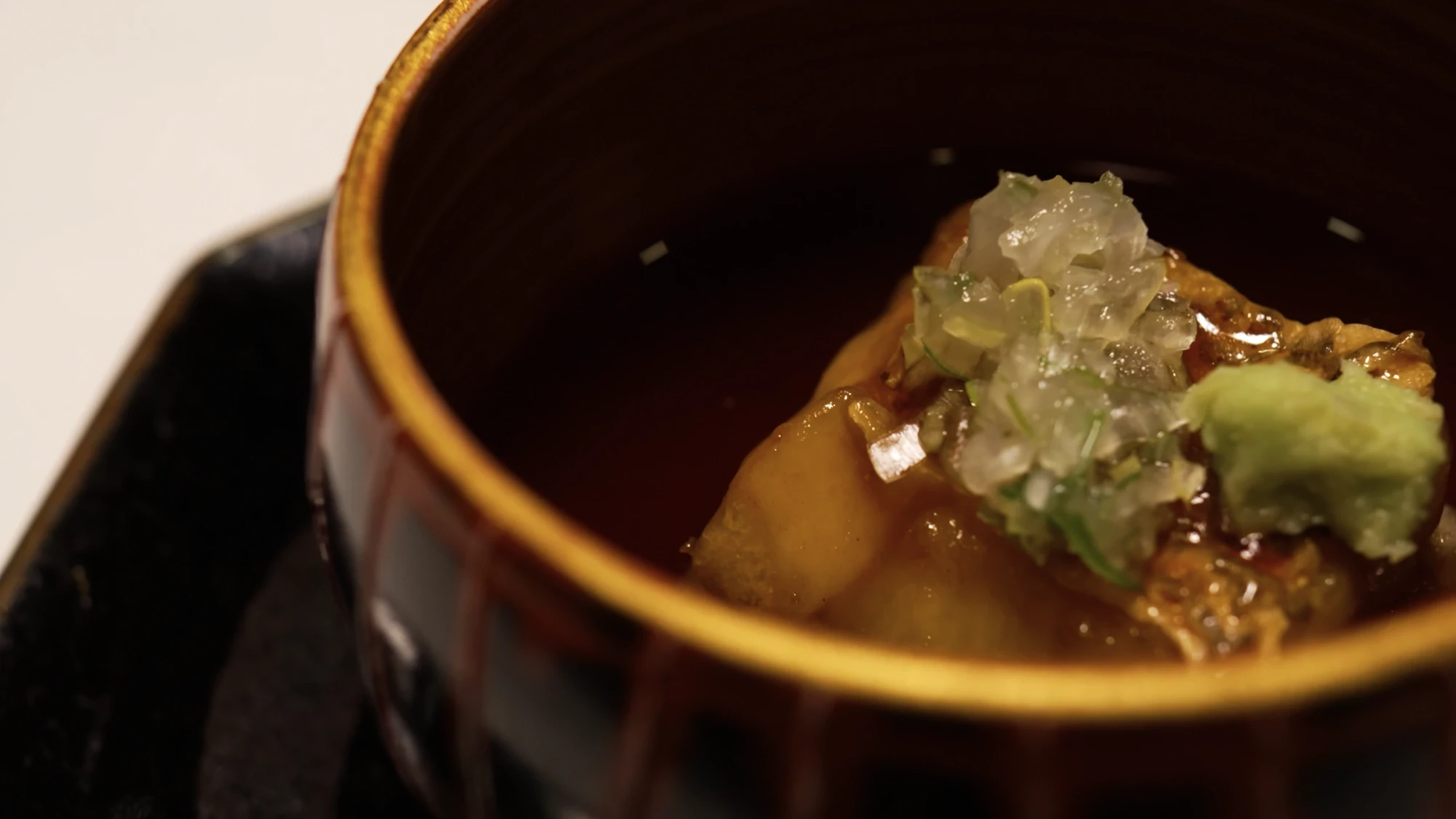 A simmered dish in a glazed bowl at Kurokawa Onsen, finished with a grated garnish