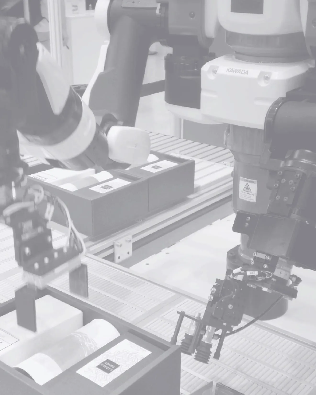 Roboterarme sortieren Pakete auf Fließband in Fabrik, zeigen moderne Automatisierung.