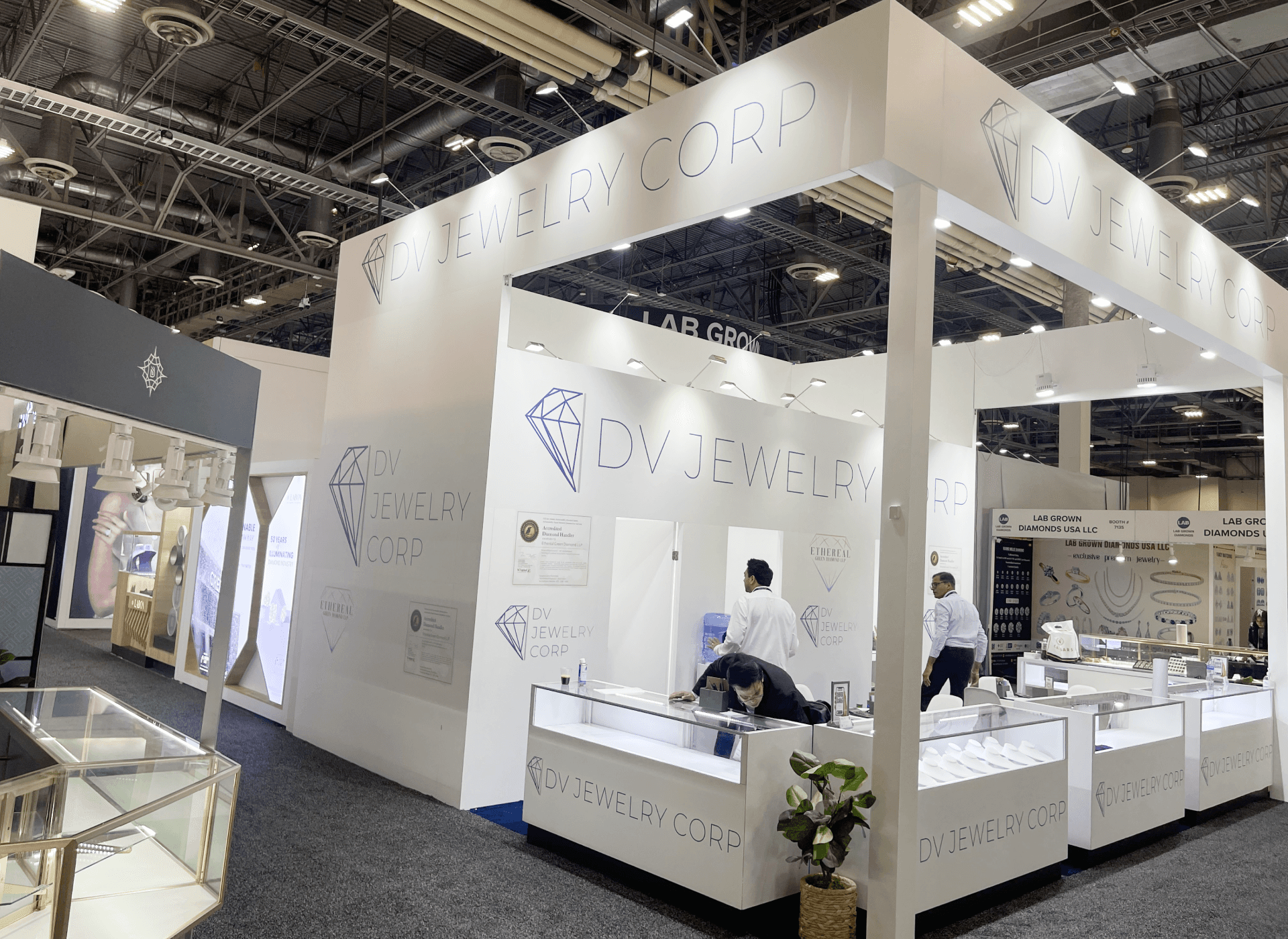 DV Jewelry JCK 2023 20x20 booth at The Venetian Expo Las Vegas – brand wall graphics install and alignment for diamond and lab-grown jewelry buyer messaging