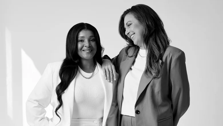 Sēkret founders Roz and Zola standing together in a bright studio, in black and white