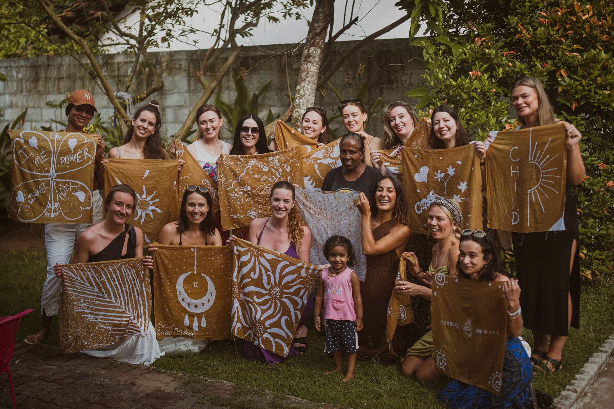 a group of women standing on top of a sandy beach