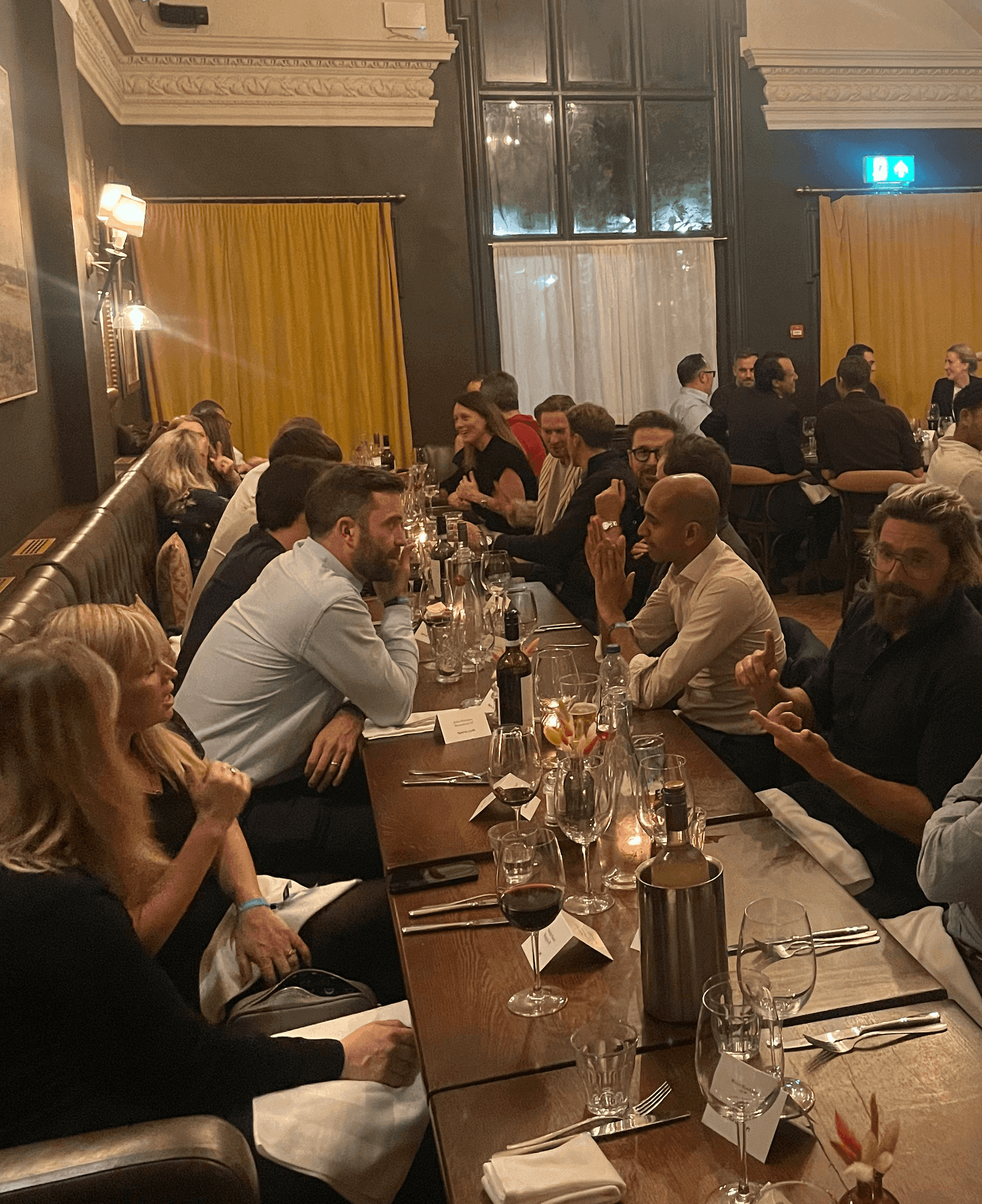A group of people having a discussion over a meal