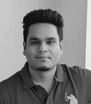 Close-up of a tree stump showing growth rings and a textured brown wood surface.