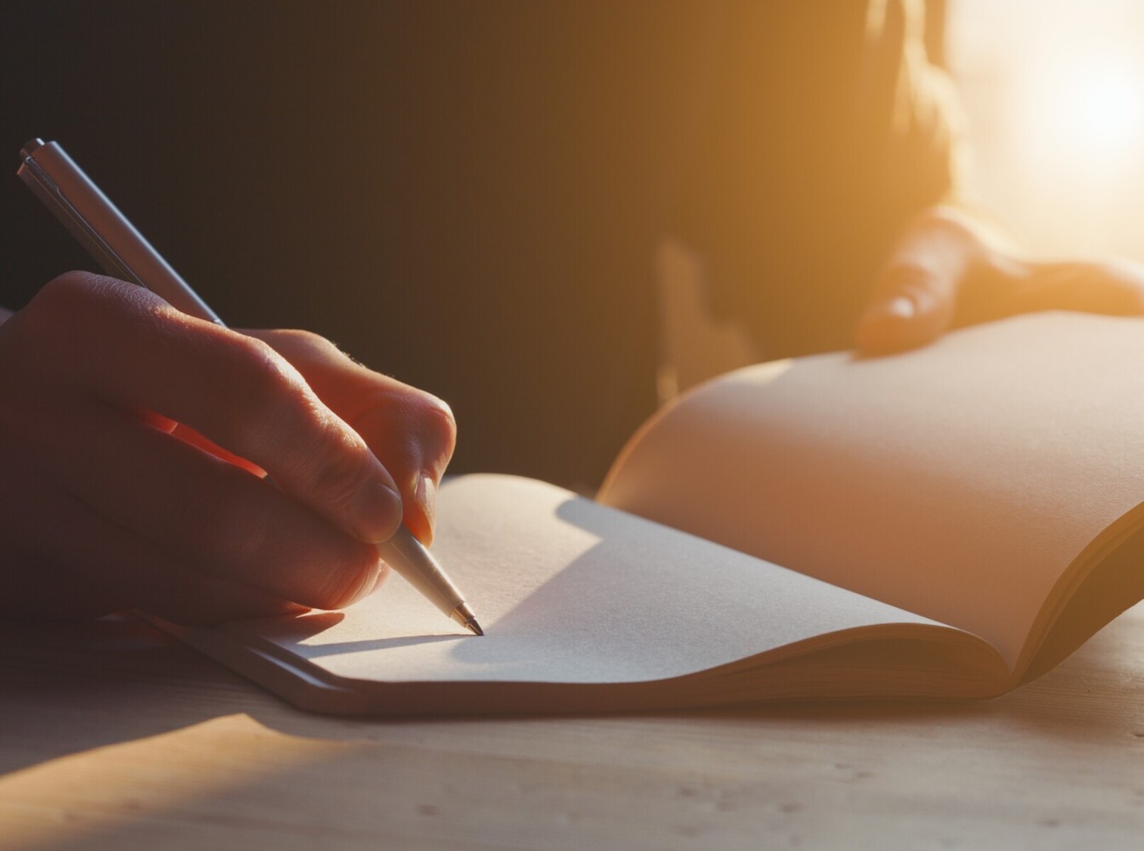 woman writing in a notebook to track her symptoms and weight gain after birth control