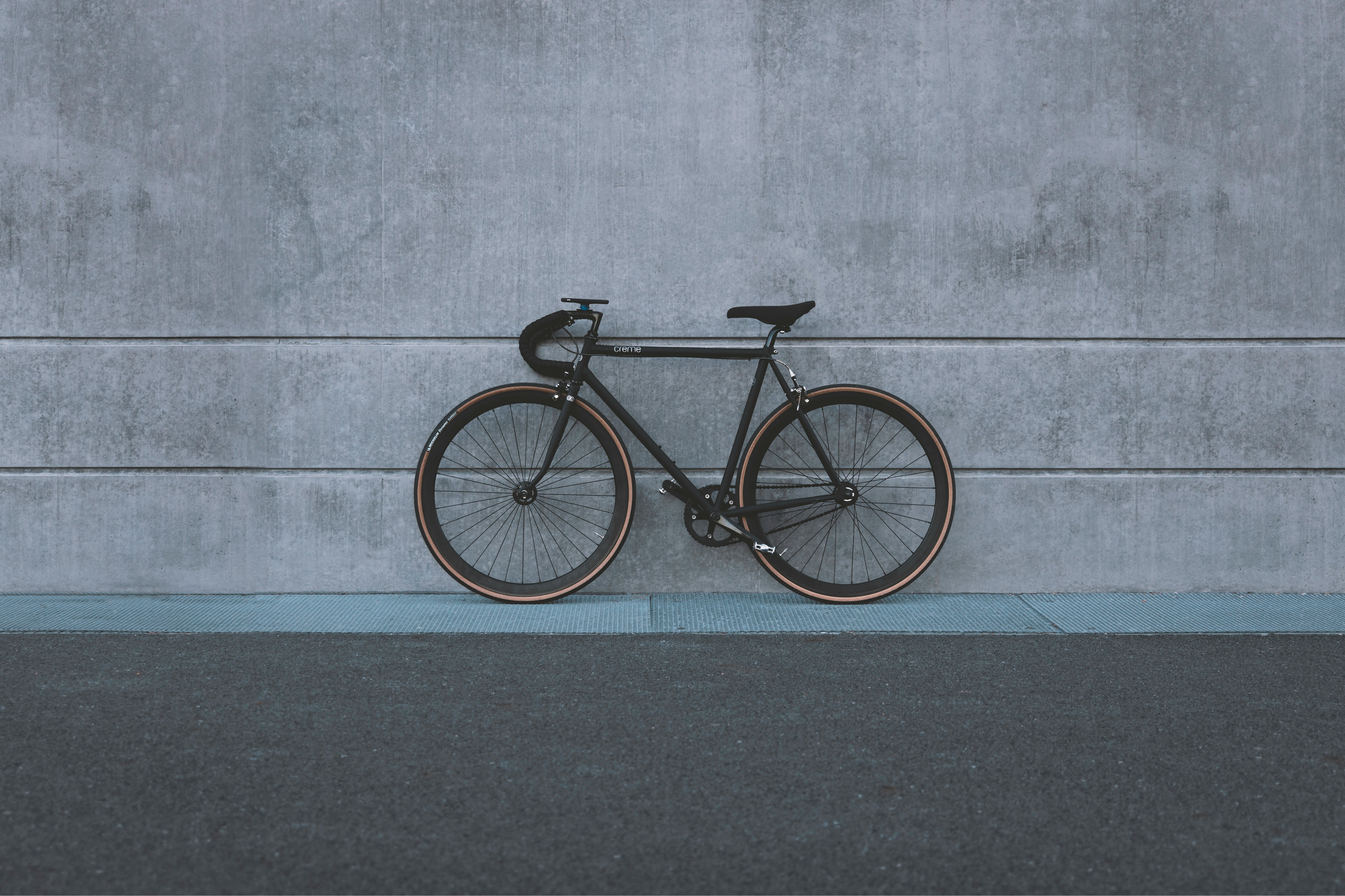 A bicycle is leaning against the wall.