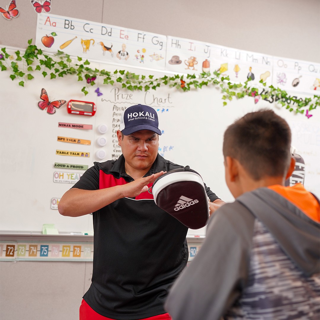 Elementary children developing coordination and self-defense skills in jiu-jitsu program