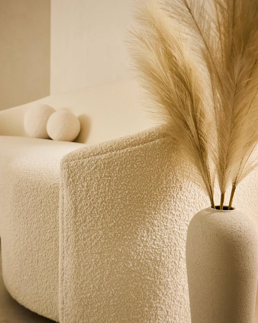 Textured lounge seating and ceramic vase decor in Terra Dental NYC reception waiting area.