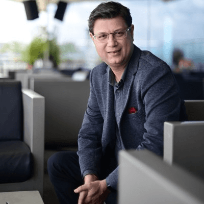 Black and white portrait of a smiling person with curly hair